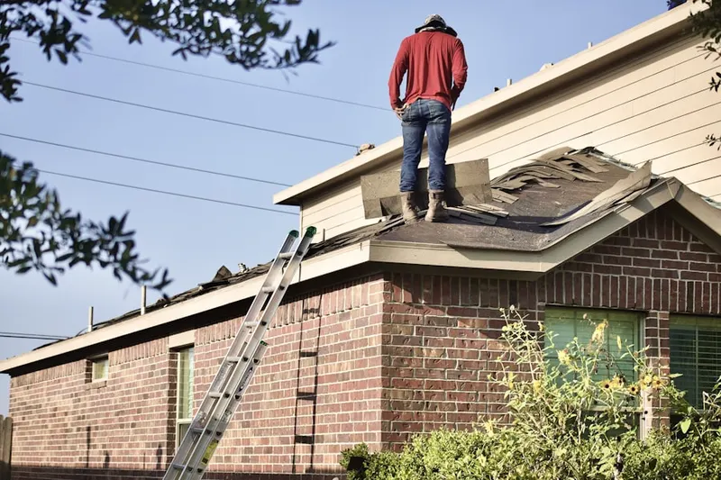 Professional roofer working on a residential roof in Moylan